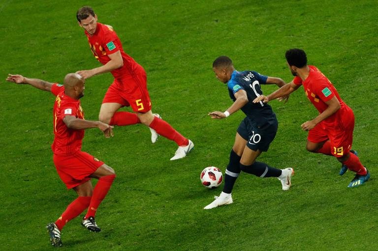 France's forward Kylian Mbappe (C) runs with the ball as he vies for it with Belgium's midfielder Moussa Dembele (R), Belgium's defender Jan Vertonghen (2nd L) and Belgium's defender Vincent Kompany (L) during the Russia 2018 World Cup semi-final football match between France and Belgium at the Saint Petersburg Stadium in Saint Petersburg on July 10, 2018. (Photo by Adrian DENNIS / AFP) / RESTRICTED TO EDITORIAL USE - NO MOBILE PUSH ALERTS/DOWNLOADS (Photo credit should read ADRIAN DENNIS/AFP via Getty Images)