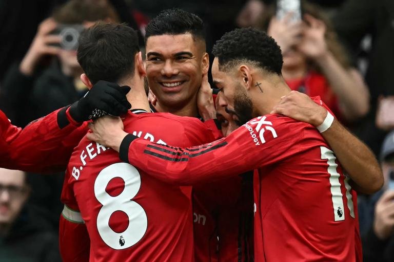 Manchester United's Brazilian midfielder #18 Casemiro (C) celebrates with teammates after scoring the team's first goal during the English Premier League football match between Manchester United and Fulham at Old Trafford in Manchester, north west England, on February 1, 2026. (Photo by Paul ELLIS / AFP via Getty Images) / RESTRICTED TO EDITORIAL USE. No use with unauthorized audio, video, data, fixture lists, club/league logos or 'live' services. Online in-match use limited to 120 images. An additional 40 images may be used in extra time. No video emulation. Social media in-match use limited to 120 images. An additional 40 images may be used in extra time. No use in betting publications, games or single club/league/player publications. /