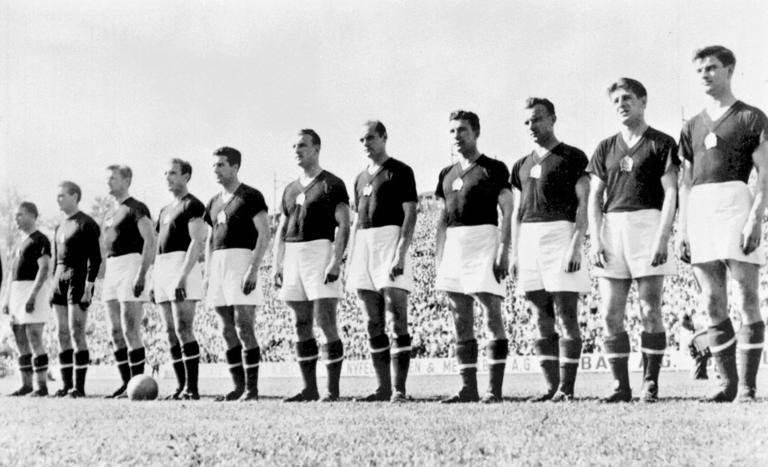 The Hungarian national soccer team is lined up during the national anthem before its World Cup first round soccer match against West Germany 20 June 1954 in Basel. (From L : Ferenc Puskas, Gyula Grosics, Gyula Lorant, Nandor Hidegkuti, Jozsef Boszik, Mihaly Lantos, Jeno Buzansky, Jozsef Zakarias, Jozsef Toth II, Zoltan Czibor, Sandor Kocsis). AFP PHOTO (Photo by STAFF / AFP) (Photo by STAFF/AFP via Getty Images)