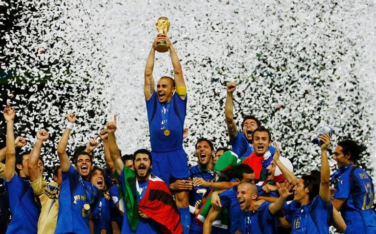 BERLIN - JULY 09: The Italian players celebrate as Fabio Cannavaro of Italy lifts the World Cup trophy aloft following victory in a penalty shootout at the end of the FIFA World Cup Germany 2006 Final match between Italy and France at the Olympic Stadium on July 9, 2006 in Berlin, Germany. (Photo by Shaun Botterill/Getty Images)