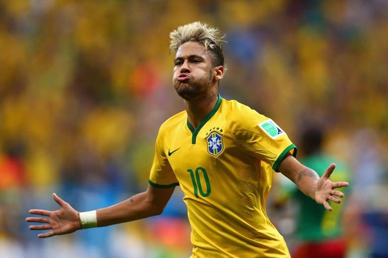 BRASILIA, BRAZIL - JUNE 23: Neymar of Brazil celebrates scoring his team's second goal and his second of the game during the 2014 FIFA World Cup Brazil Group A match between Cameroon and Brazil at Estadio Nacional on June 23, 2014 in Brasilia, Brazil. (Photo by Clive Brunskill/Getty Images)