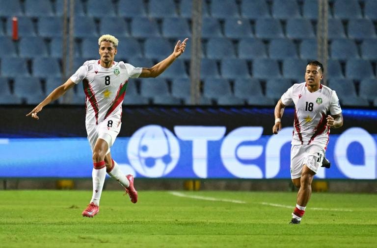 Suriname's midfielder #08 Justin Lonwijk (L) celebrates next to teammate midfielder #18 Jayden Turfkruier (R) after scoring his team's first goal during the 2026 FIFA World Cup Concacaf qualifier football match between El Salvador and Suriname at the Cuscatlan stadium in San Salvador on June 10, 2025. (Photo by Marvin RECINOS / AFP) (Photo by MARVIN RECINOS/AFP via Getty Images)